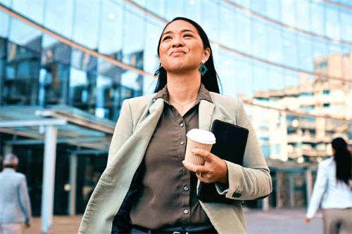 Confident businesswoman walking outside office building